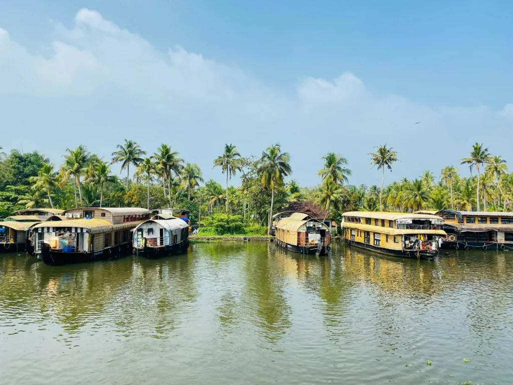 Lush green backwaters of Kerala, India during monsoon season with serene rivers and traditional houseboats