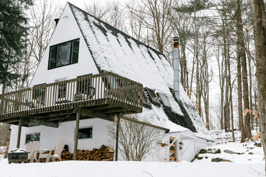 Snow-covered bridge and cabins in Stowe Vermont during cozy winter evening