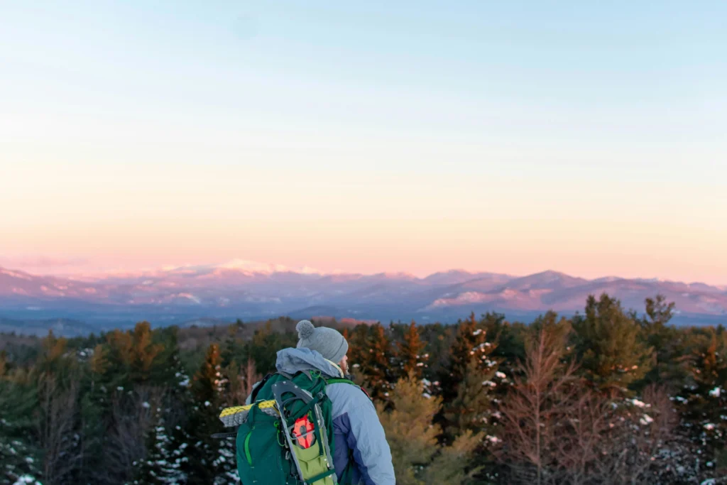 Traveler snowshoeing through snow-covered trails in Yellowstone National Park