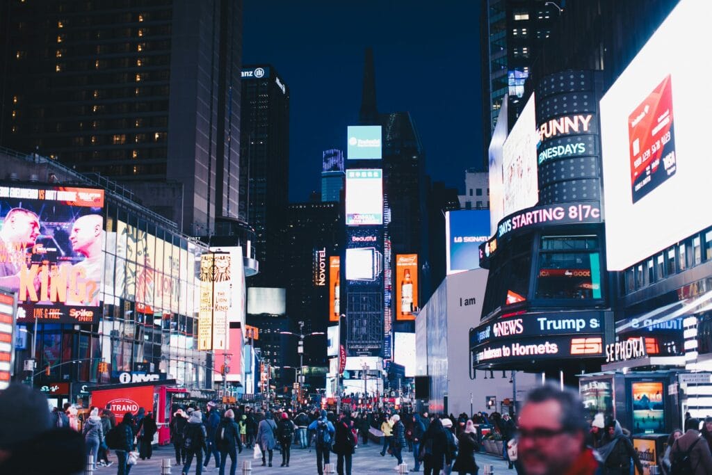 Times Square at night with neon lights and billboards, one of the top things to do in New York City