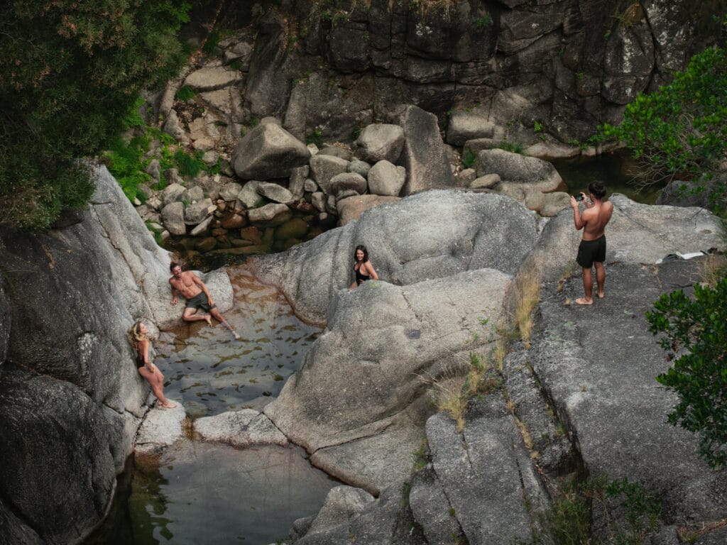 Tourists soaking in a natural hot spring surrounded by mountains in Colorado