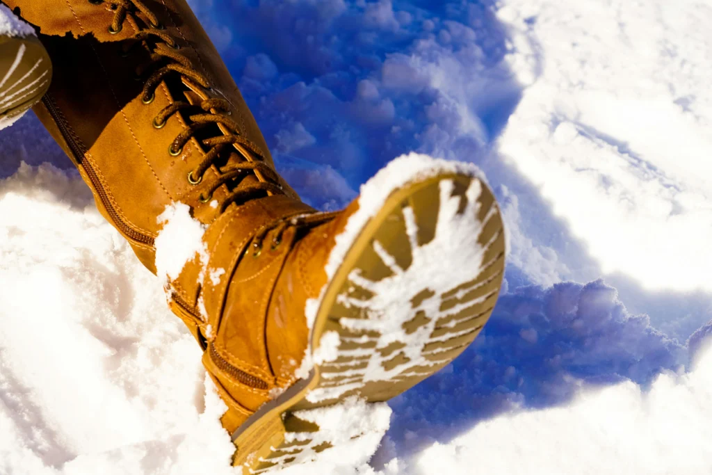Waterproof insulated boots and sneakers packed for winter travel