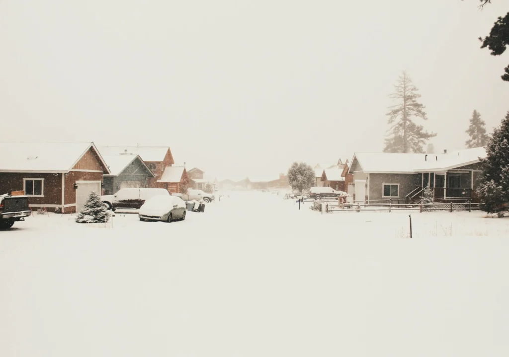 Snowy cabins around Big Bear Lake California with pine trees and winter sky