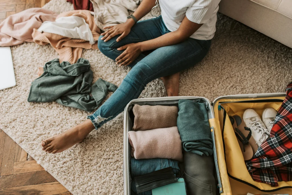 Traveler organizing suitcase neatly – travel packing tips for efficient trips